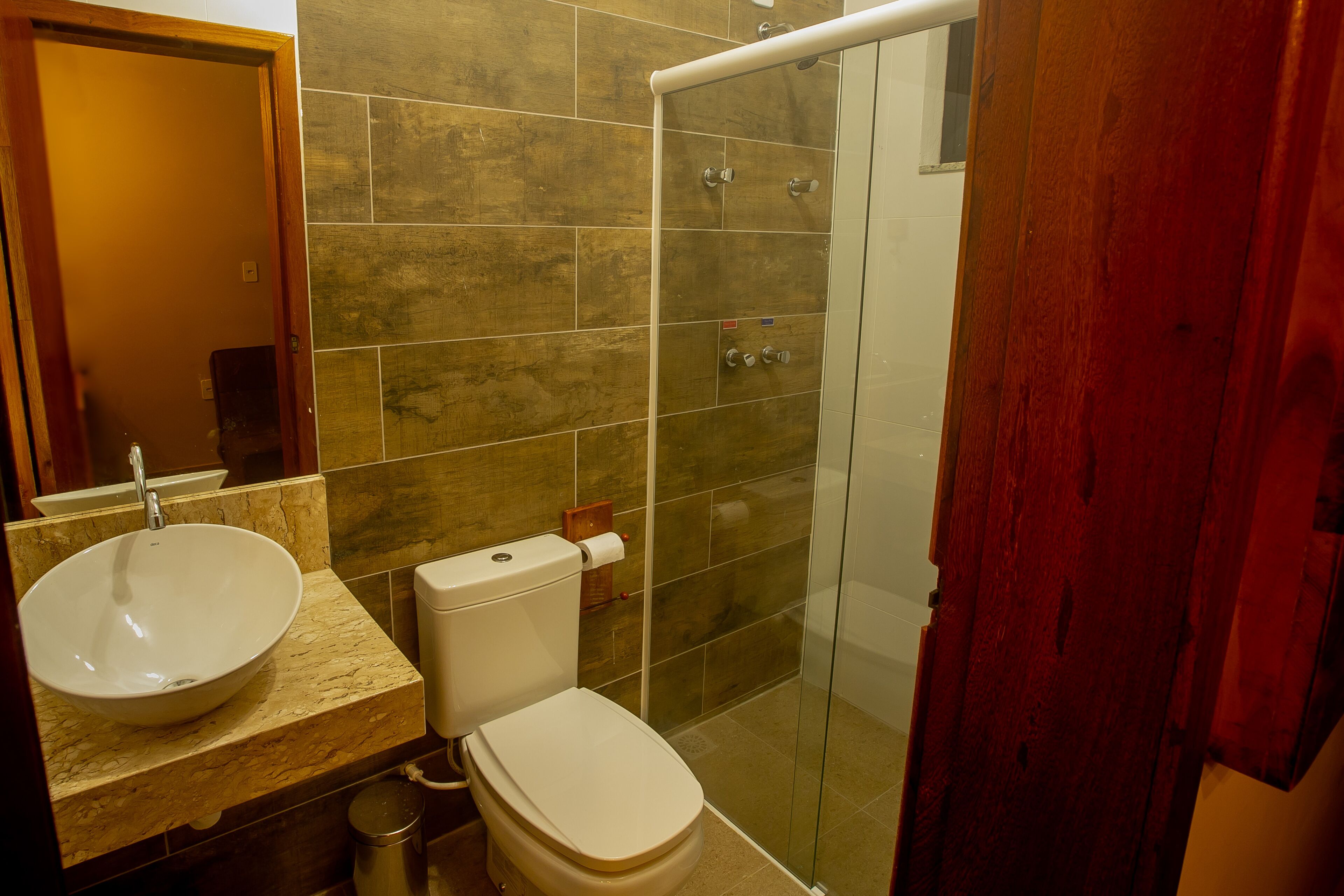 A bathroom with a sink, toilet, and shower.