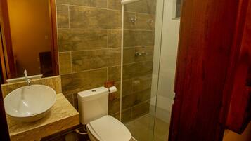 A bathroom with a sink, toilet, and shower.