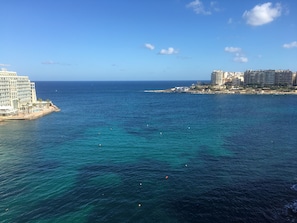 A coastal view with a large hotel and several high-rise buildings. - Seafront Penthouse Triplex- Roof Terrace & Hot Tub (St. Julian's)