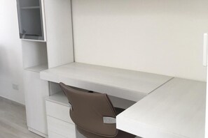 A white desk with a brown chair, a white shelf, and a white drawer unit. - Seafront Penthouse Triplex- Roof Terrace & Hot Tub (St. Julian's)