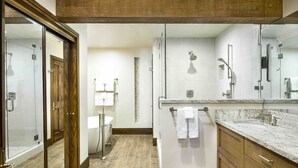 A modern bathroom with a glass shower enclosure, a wooden vanity, and a large mirror. - Luxury Three Bedroom Suite with Mountain Views and Three Hot Tubs 3 Apartment Hotel by RedAwning (Park City)