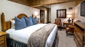 A bedroom with a large bed, wooden headboard, a desk, a chair, and a dresser. - Luxury Three Bedroom Suite with Mountain Views and Three Hot Tubs 3 Apartment Hotel by RedAwning (Park City)