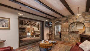 A cozy interior with stone walls, a wooden ceiling, and leather seating. - Villa Cupido With Private Pool (Vinodol)