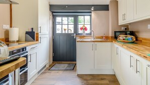 A compact kitchen with a microwave, toaster, and a small sink.