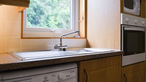 A kitchen with a built-in dishwasher, a microwave, and a double oven.