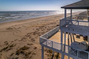 A beach view with a wooden deck and outdoor seating. - Deck & Ocean Views: Beachfront Home in Freeport (Freeport)