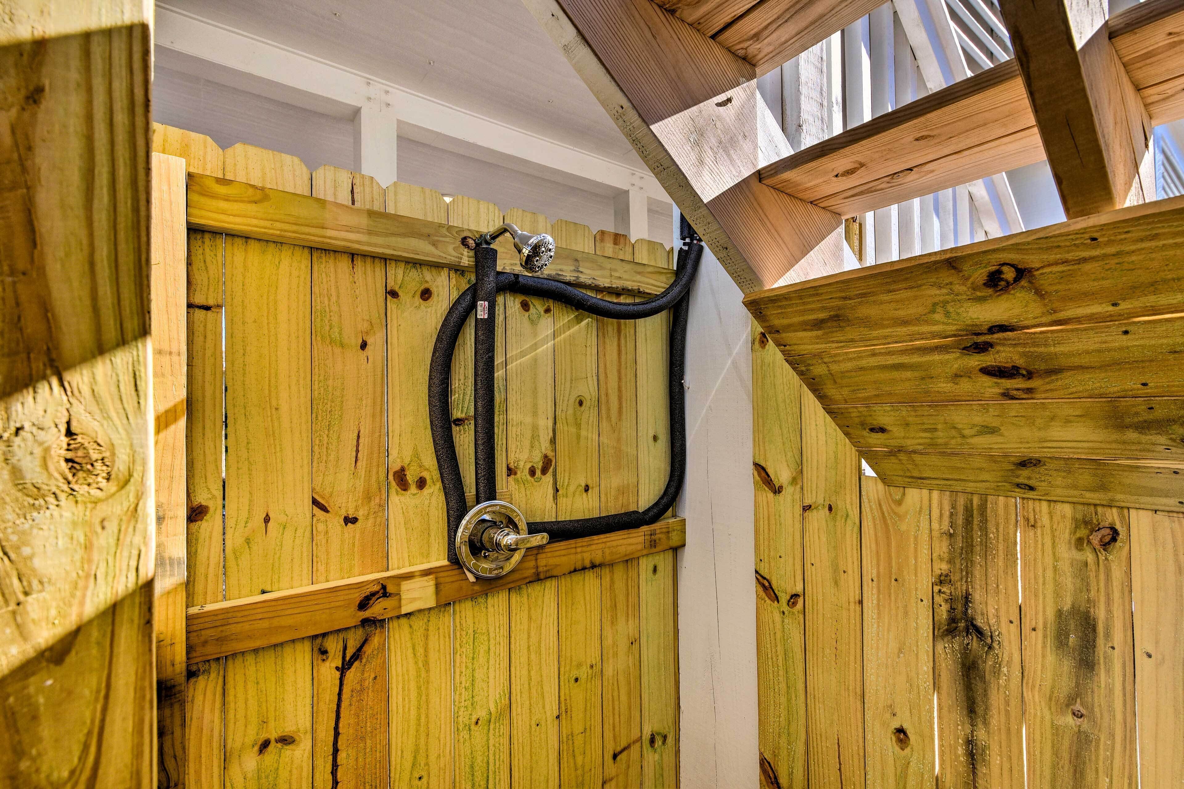 A wooden structure with a metal pipe and valve, likely part of a water system.