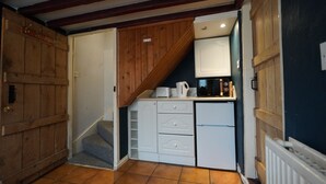 A compact kitchen with a microwave, a coffee maker, and a small refrigerator. - Cosy Victorian Cottage in Crowborough with Log Burner and parking (Crowborough)