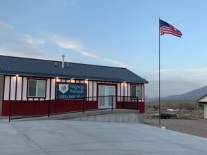 A building with a sign for 'Nightly Rentals' and an American flag. - Home Base Resort  #3 (Joseph)
