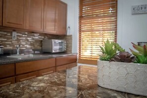 Enjoy cooking in this well-equipped kitchen with a microwave and toaster.