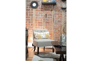 Relax in this inviting living room with a comfortable armchair and a convenient table.