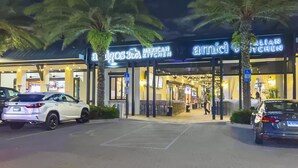 A restaurant named 'Amici Italian Kitchen' with outdoor seating and palm trees. - Someday Came 4 Bedroom Home by RedAwning (Panama City Beach)