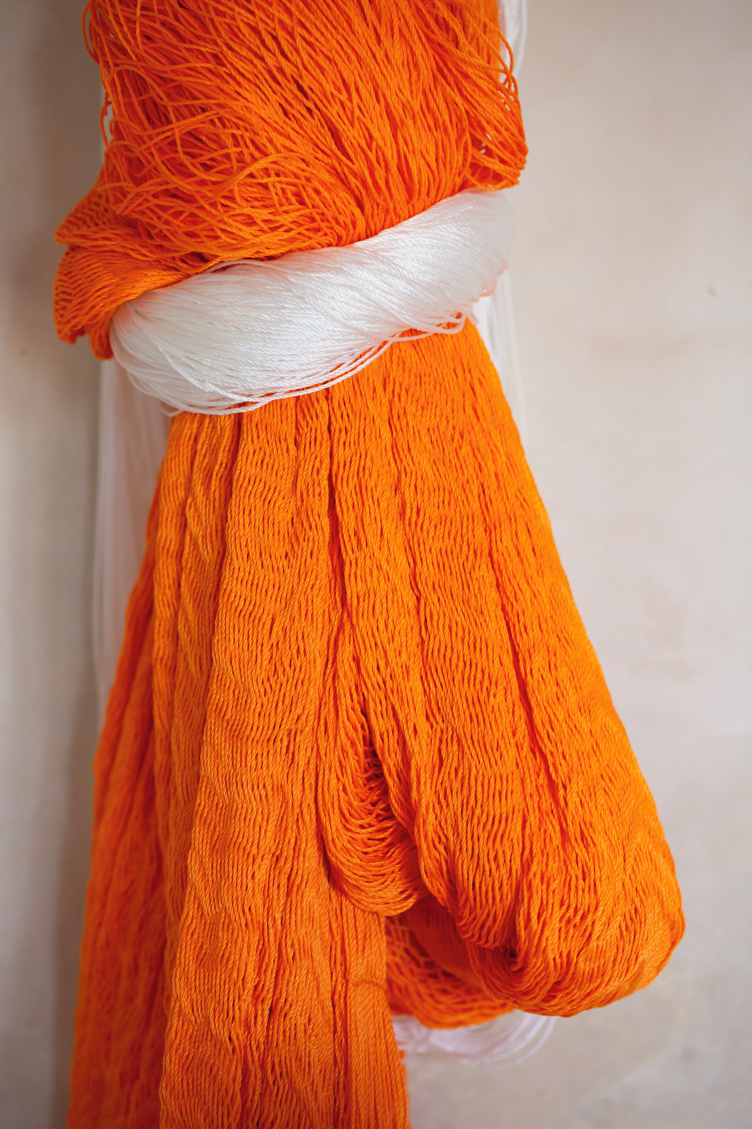 A spool of orange yarn.