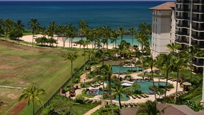 A resort with a pool area, palm trees, and a view of the ocean. - Oceanfront 2BR 2BA Villa   Top-Floor Corner    Walk to Disney Aulani    Sleeps 6 (Kapolei)