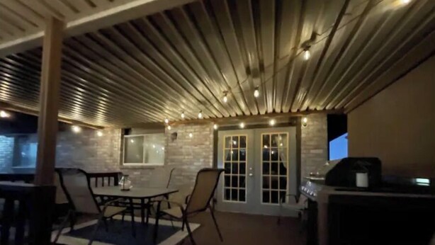 An outdoor patio area with a table and chairs, a grill, and a brick wall. - Beautiful San Antonio Home near SeaWorld/Six Flags (San Antonio)