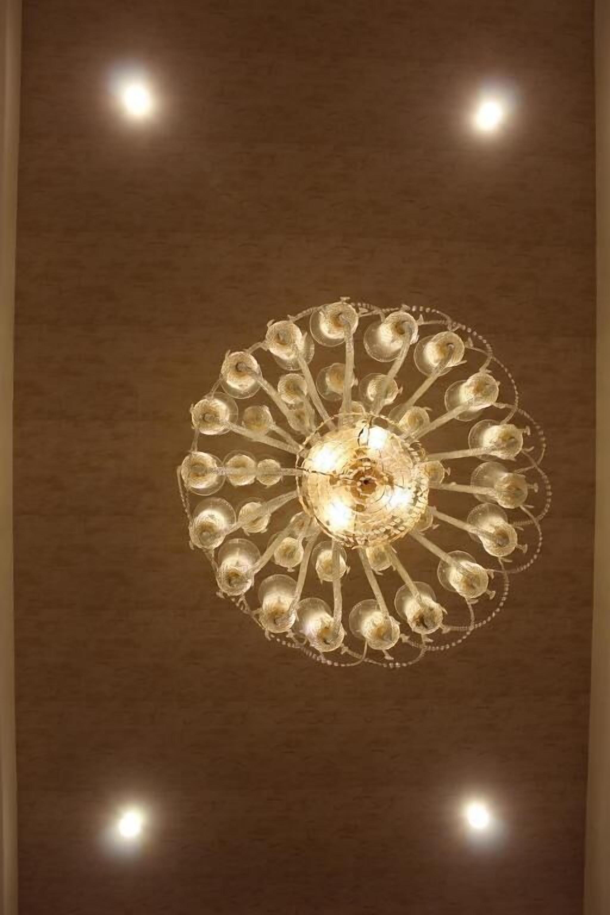 Ein Kronleuchter mit kreisförmigem Design und mehreren Lichtquellen.