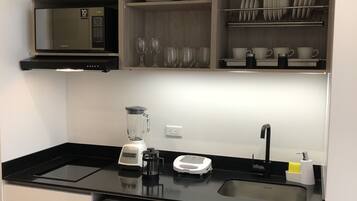 Fridge, microwave, coffee/tea maker, cookware/dishes/utensils