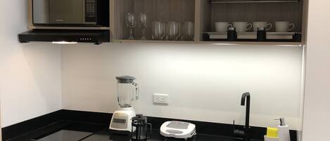 Fridge, microwave, coffee/tea maker, cookware/dishes/utensils