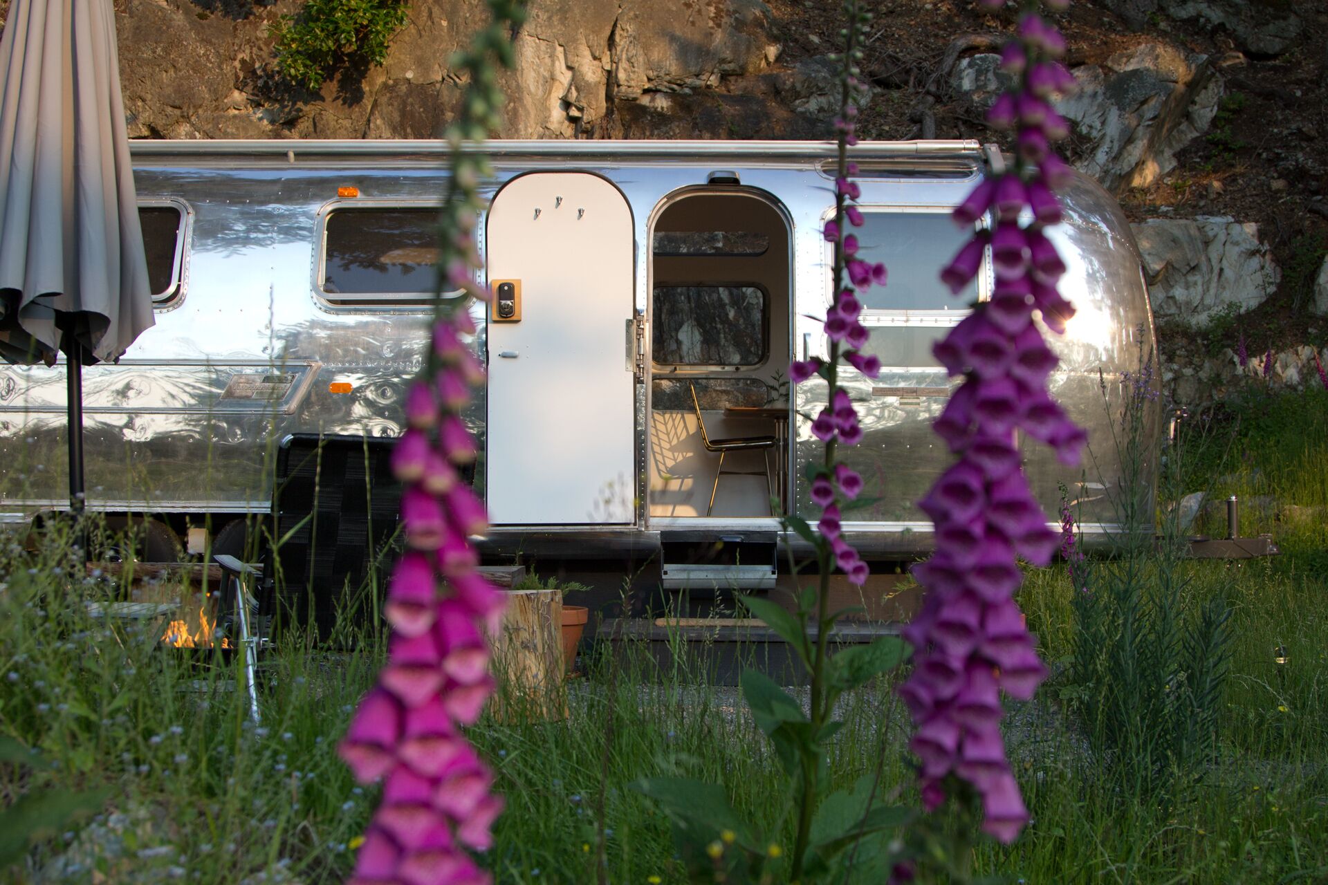 A camper with a small enclosed living area, a door, and a window.