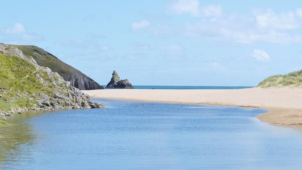 A coastal landscape with a rocky outcrop, sandy beach, and calm water. - 2 bedroom accommodation in Valast Hill, near Stackpole (Valast Hill, near Stackpole)