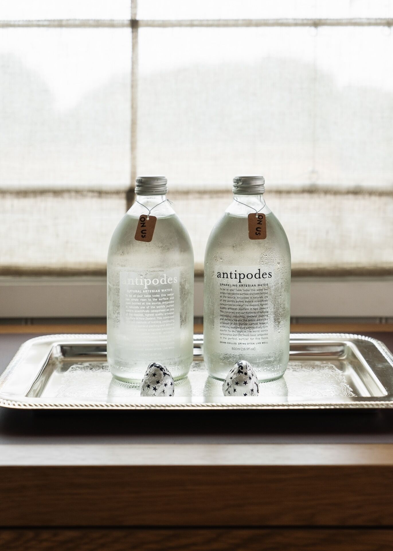 Two bottles of Antipodes sparkling artesian water on a tray.