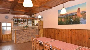 Un restaurant au décor intérieur en bois, avec un comptoir en briques et une table dressée pour quatre personnes.