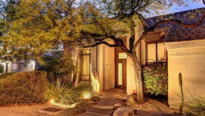 A residential property with a well-maintained garden, a stone pathway leading to the entrance, and a traditional architectural style. - Casa Buena—Luxurious Retreat w/2 Masters & Views! (Phoenix)