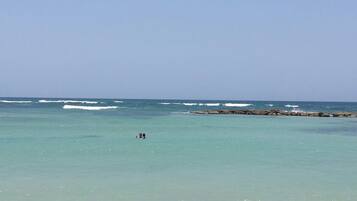 On the beach, white sand, beach towels, beach massages
