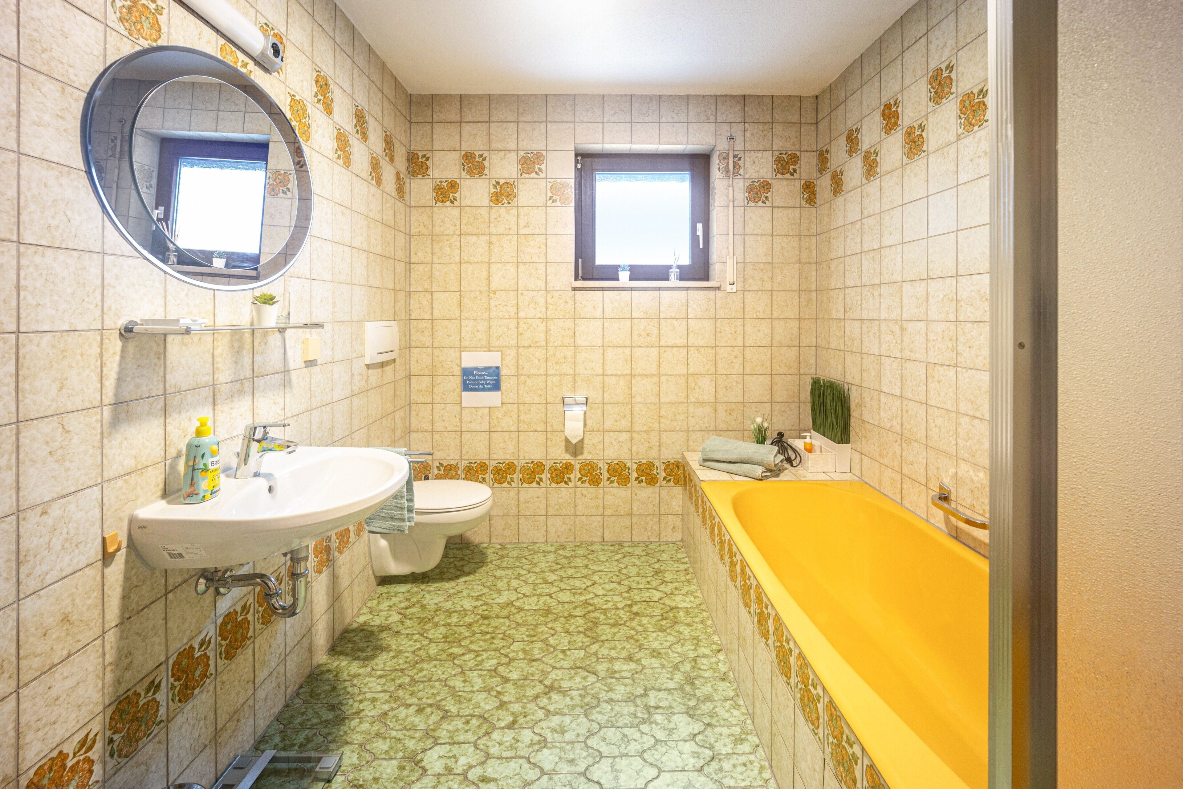 A bathroom with a sink, toilet, and bathtub.