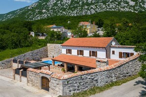 A stone-walled house with a tiled roof, a swimming pool, and a stone staircase leading to the entrance. - Villa Cupido With Private Pool, Drivenik, Croatia (Drivenik)