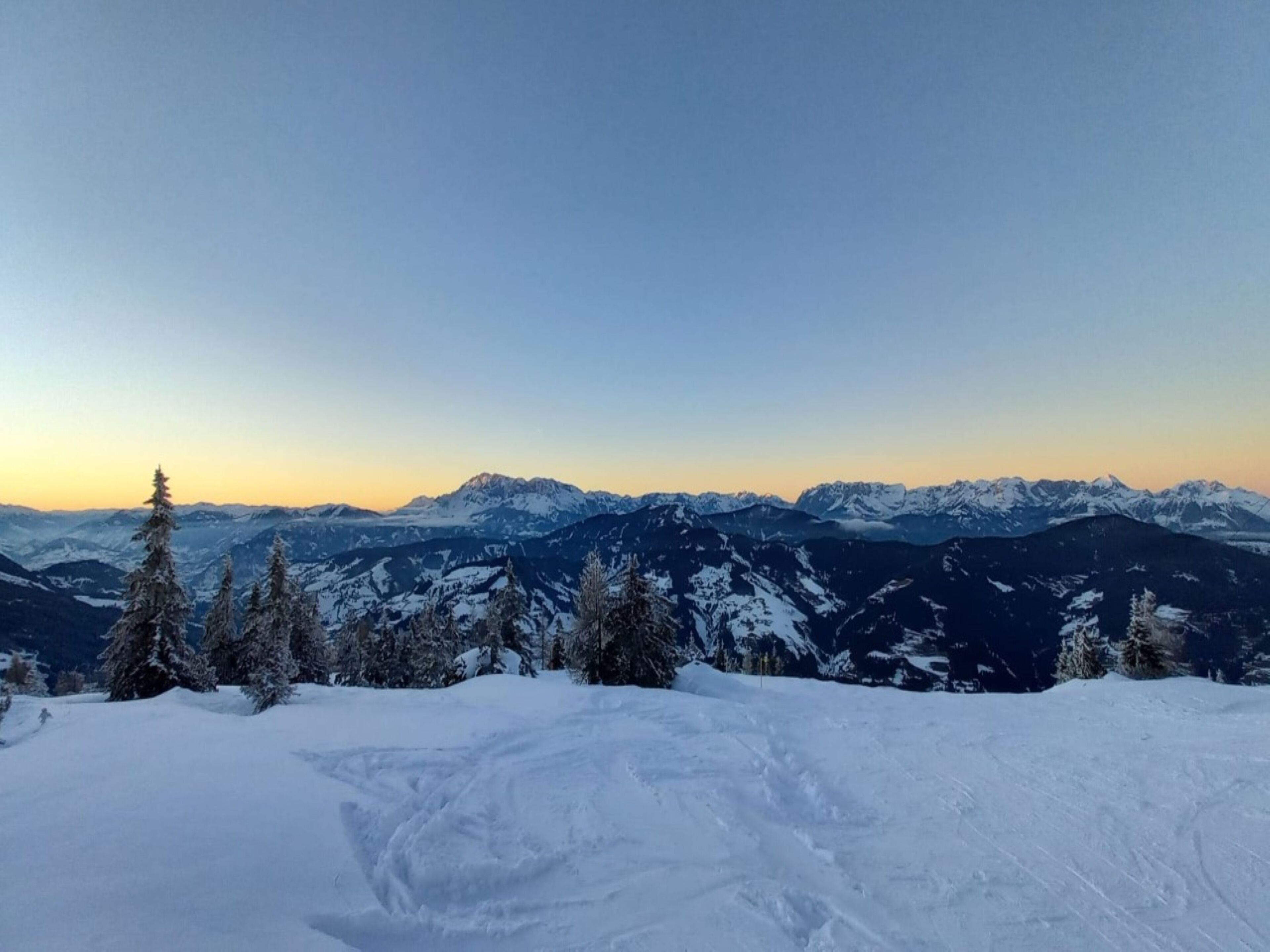 A snowy mountain landscape with clear skies.