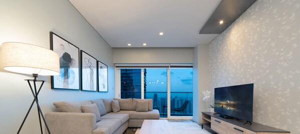 Deluxe Apartment | Living area | 55-inch Smart TV with cable channels, TV