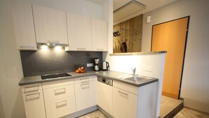 A modern kitchen with light wood cabinets, a stainless steel sink, and a built-in oven. - Chalet in Lungau near Ski Slopes (Sankt Margarethen im Lungau)