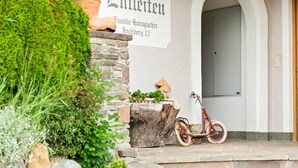 A building entrance with a sign reading "Entleiten" and a red bicycle parked outside. - Apartment in Hollersbach near Kitzbühel ski lift (Hollersbach im Pinzgau)