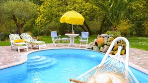 A swimming pool with lounge chairs and a hammock. - Villa in France near Beach & Private Pool (Anglet)