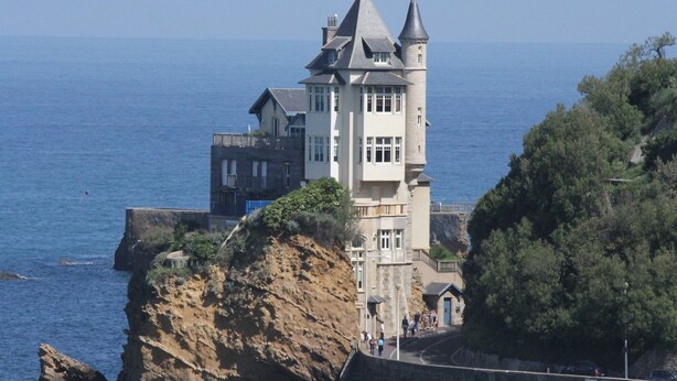 A coastal castle with multiple towers, situated on a cliff overlooking the sea. - Villa in France near Beach & Private Pool (Anglet)