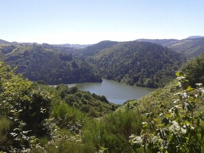 A natural landscape with a lake surrounded by forested hills. - Charming Farmhouse in Cros-de-Géorand (Cros-De-Géorand)