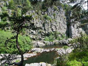 A rocky landscape with a small stream and dense greenery. - Charming Farmhouse in Cros-de-Géorand (Cros-De-Géorand)
