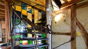 Una escalera de caracol con barandillas metálicas y un interior de madera.
