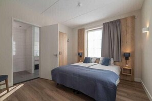 Relax in this serene bedroom with a large bed, bedside tables, and a walk-in closet.