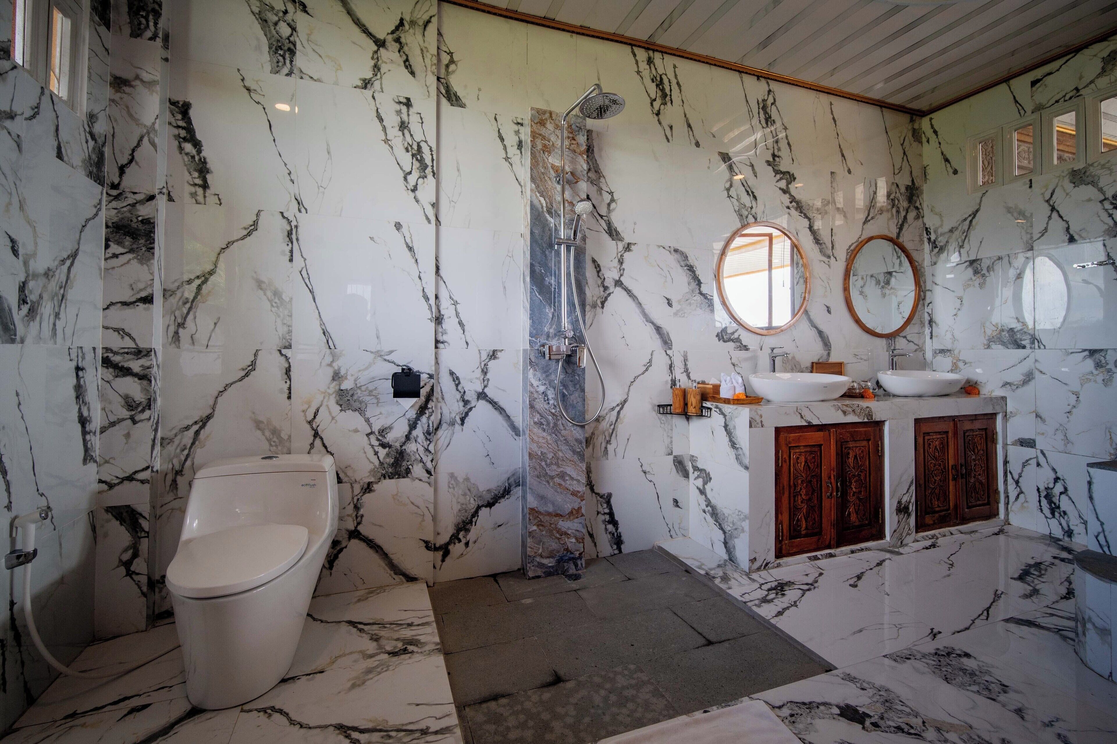 A bathroom with a toilet, a sink, and a shower.