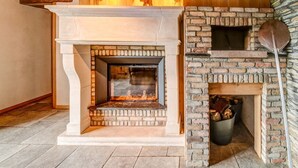 A fireplace with a stone surround and a wooden mantel. - Riverside Villa with Charm (Léglise)
