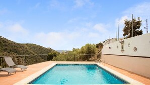 A rectangular pool with a tiled deck, surrounded by a metal fence. - Casa La Loma with Pool (Andalucía)