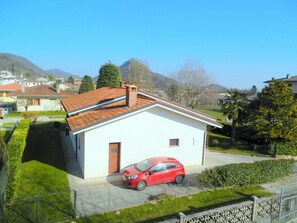 A small white building with a red car parked in front. - Villa in Northern Italy near Borgo di Toppo (Travesio)