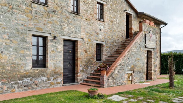 A stone building with a staircase leading to the entrance.