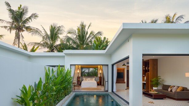 A modern hotel room with a private pool, a dining area with a table and chairs, and a living room with a sofa and a TV. - WAKA VILLA Private Resort & Spa 16 + Adults Only (Siem Reap)