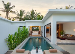 A modern hotel room with a private pool, a dining area with a table and chairs, and a living room with a sofa and a TV. - WAKA VILLA Private Resort & Spa 16 + Adults Only (Siem Reap)