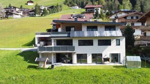 Ein modernes, zweistöckiges Gebäude mit Flachdach, großen Fenstern und einem Balkon.