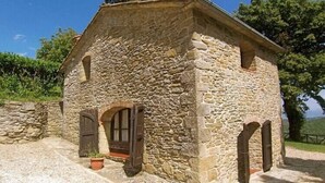 A stone building with a pitched roof, a central doorway, and two side windows. - Quaint cottage with pool (Anghiari)