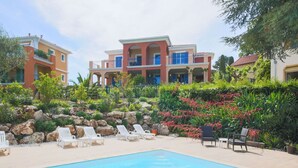 A swimming pool with lounge chairs and a landscaped garden area.